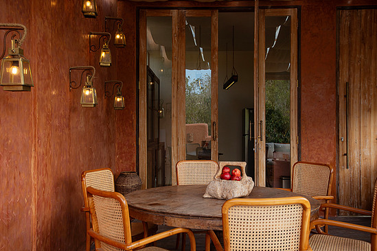 Brass lanterns, terracotta walls, sailcloth pergola